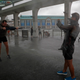 People play in the strong wind from Typhoon Hato on the waterfront of Victoria Habour in Hong Kong, Wednesday, Aug. 23, 2017. A powerful typhoon barreled into Hong Kong on Wednesday, forcing offices and schools to close and leaving flooded streets, shattered windows and hundreds of canceled flights in its wake. Typhoon Hato came within 60 kilometers (37 miles) of Hong Kong, close enough to be considered a direct hit under Hong Kong's storm warning system. It was headed toward the western side of mainland China's Pearl River Delta. (AP Photo/Vincent Yu)